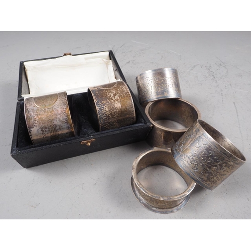 311 - A cased pair of silver napkin rings and four other silver napkin rings, 9.8oz troy approx