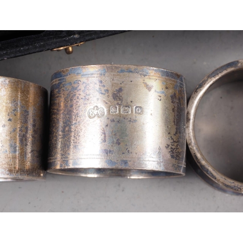 311 - A cased pair of silver napkin rings and four other silver napkin rings, 9.8oz troy approx