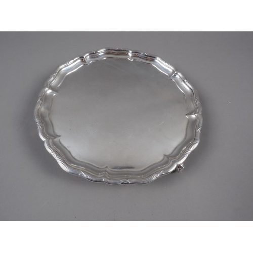 317 - A silver pie crust card tray, on three scrolled feet, 12.3oz troy approx