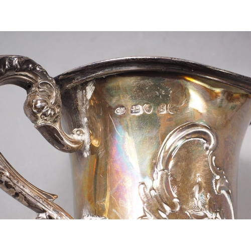 318 - A Georgian silver pedestal mug with embossed decoration, 4