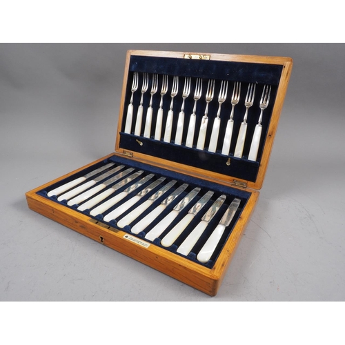 322 - A cased set of twelve silver and mother-of-pearl fruit knives and forks