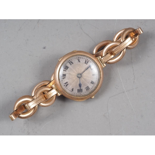 343 - A lady's 9ct gold wristwatch with silvered dial and Roman numerals, on expanding 9ct gold bracelet, ... 