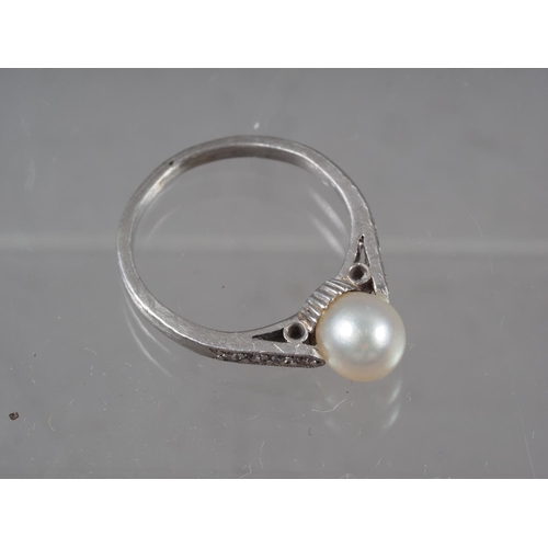 346 - A white metal, pearl and diamond dress ring, size G, 2.5g