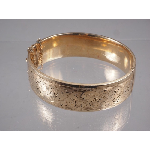 365 - A 9ct rolled gold and engraved bangle