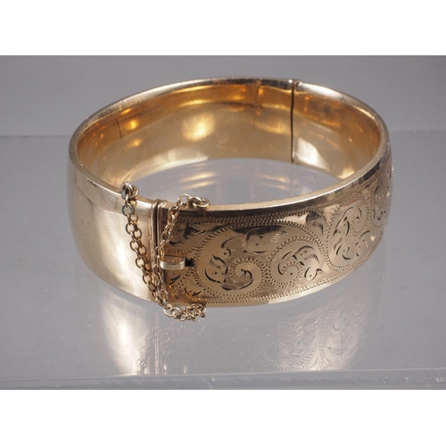 365 - A 9ct rolled gold and engraved bangle