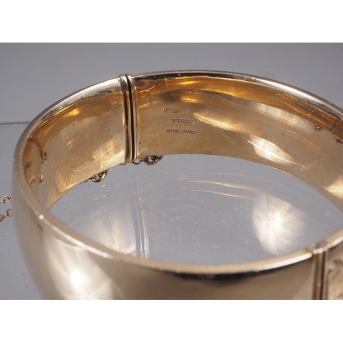 365 - A 9ct rolled gold and engraved bangle