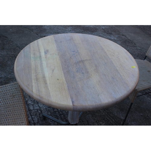 486 - An oak bistro table, on metal splay supports, 25