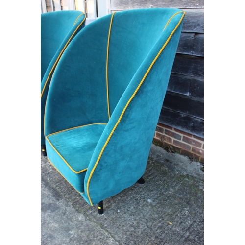 488 - A pair of deep seat arm easy chairs, upholstered in an azure velour with old gold piping, on ebonise... 