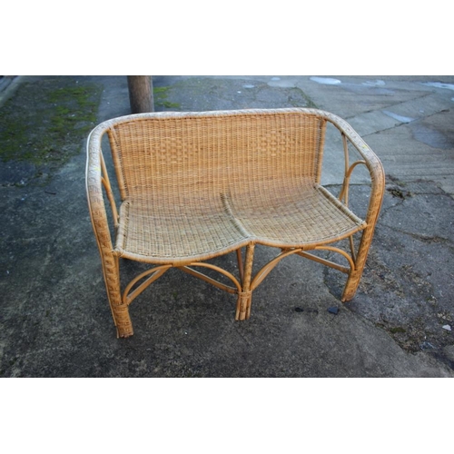 491 - A rattan two-seat settee with shaped seat rails, 42