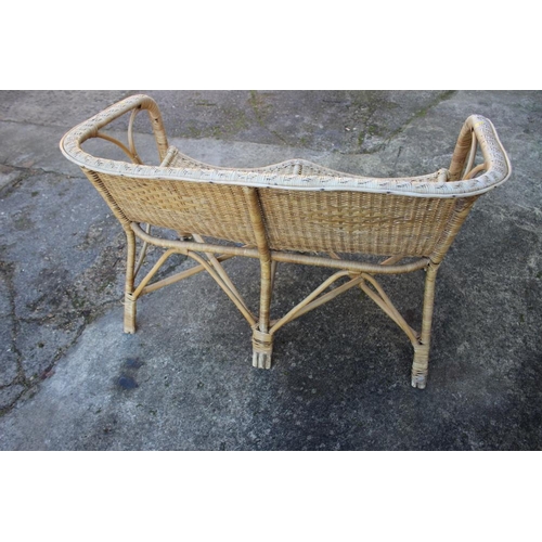 491 - A rattan two-seat settee with shaped seat rails, 42