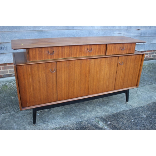 495 - A 1950s G Plan Librenza teak sideboard, fitted three drawers over two bi-fold doors, on ebonised spl... 