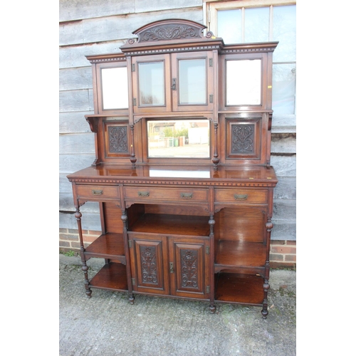 501 - An Edwardian walnut dresser, the upper section fitted three mirror panels and glazed cupboard, over ... 