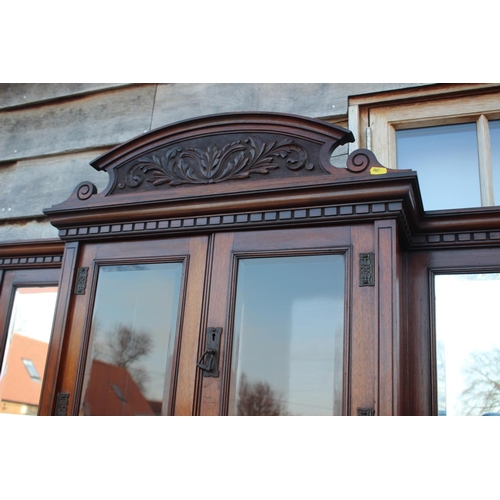 501 - An Edwardian walnut dresser, the upper section fitted three mirror panels and glazed cupboard, over ... 