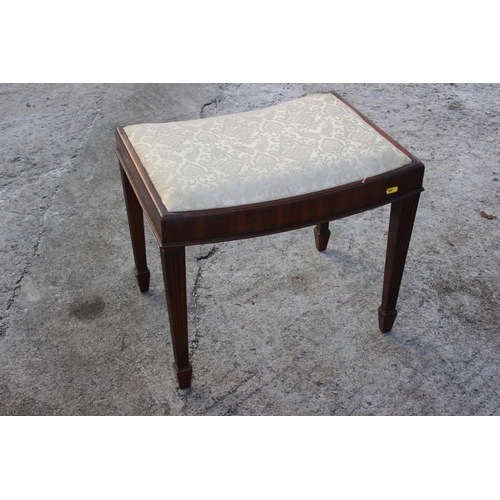 505 - A mahogany dressing stool with dished seat, on reeded supports, 21