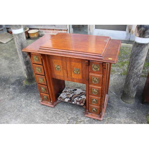 512 - A mahogany sewing machine cabinet, now converted as a desk, fitted two drawers, 34