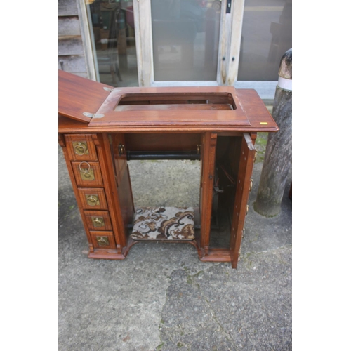 512 - A mahogany sewing machine cabinet, now converted as a desk, fitted two drawers, 34