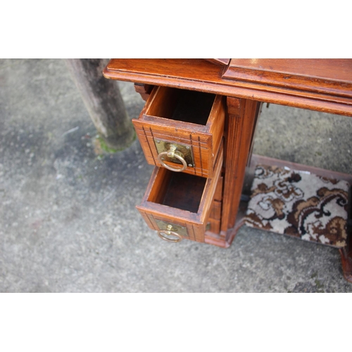 512 - A mahogany sewing machine cabinet, now converted as a desk, fitted two drawers, 34