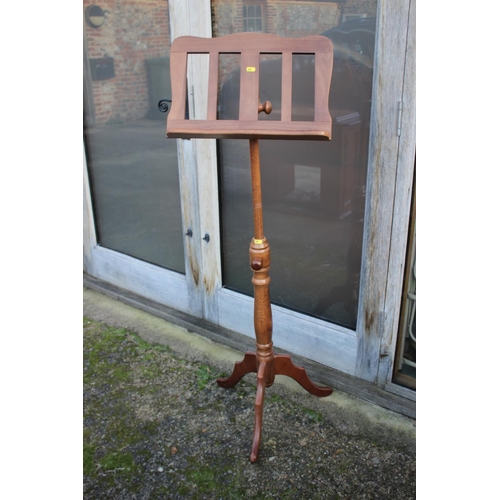 515 - A polished as walnut music stand, on tripod splay support