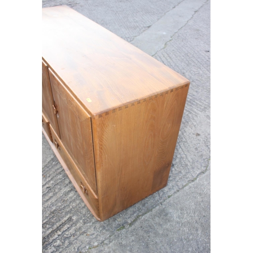 518 - A 1960s Ercol elm 429 sideboard, fitted three doors over two drawers, 52