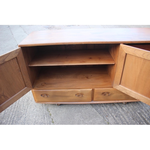 518 - A 1960s Ercol elm 429 sideboard, fitted three doors over two drawers, 52