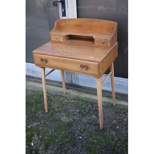 519 - A 1960s Ercol elm and beech writing table, 437/439, with stationery compartments over one long drawe... 