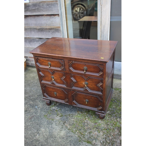 521 - An oak chest of two short and two long drawers of 17th century design with fielded panel fronts, on ... 