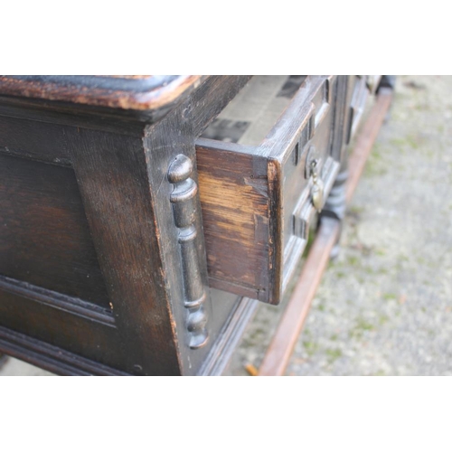 529 - An oak dresser of 18th century design, the upper section fitted shelves and two spice cupboards, ove... 