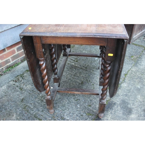 530 - An oak drop leaf dining table, on barley twist stretchered supports, 42