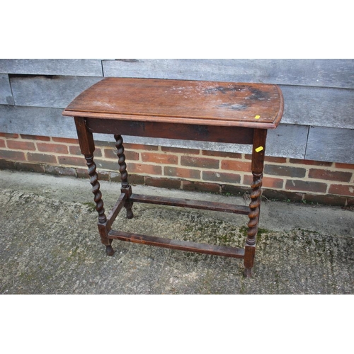 534 - An oak side table on barley twist stretchered supports, 30