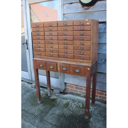 536 - An early 20th century nest of forty-eight filing drawers, on stand fitted four drawers, 43