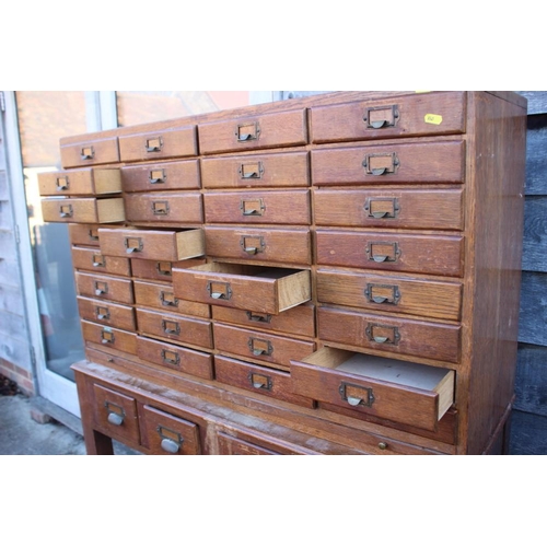 536 - An early 20th century nest of forty-eight filing drawers, on stand fitted four drawers, 43