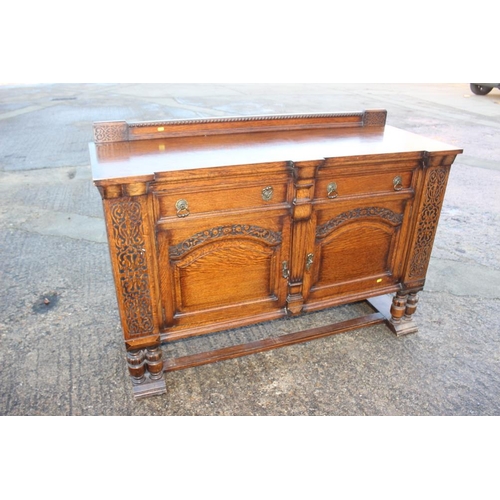 537 - A 1930s carved oak breakfront sideboard, fitted two drawers over two doors, on cluster column suppor... 