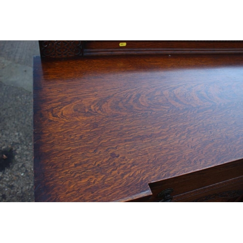 537 - A 1930s carved oak breakfront sideboard, fitted two drawers over two doors, on cluster column suppor... 