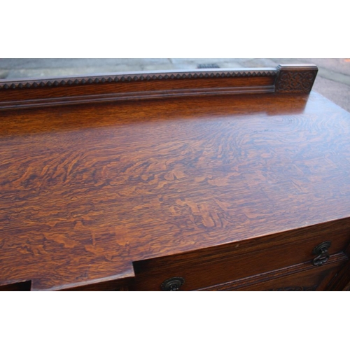 537 - A 1930s carved oak breakfront sideboard, fitted two drawers over two doors, on cluster column suppor... 