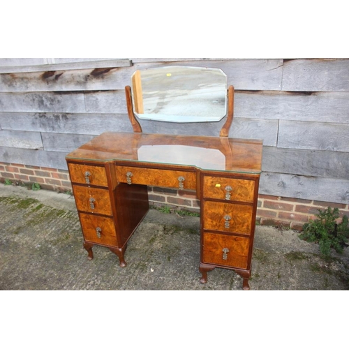 542 - A 1930s walnut inverse breakfront dressing table, fitted one long and six small drawers, on cabriole... 