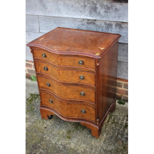 544 - A 1930s burr walnut serpentine front chest of four drawers with ring handles, on bracket feet, 24