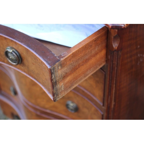 544 - A 1930s burr walnut serpentine front chest of four drawers with ring handles, on bracket feet, 24