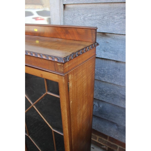 548 - A carved mahogany display cabinet enclosed lattice glazed doors, on cabriole supports, 36