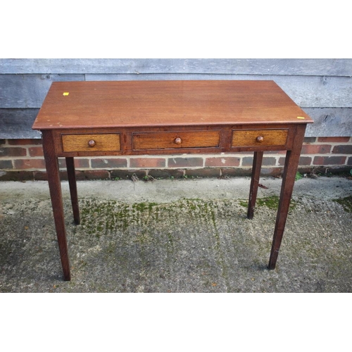 552 - An Edwardian oak side table, fitted three drawers, on square taper supports, 37 1/2