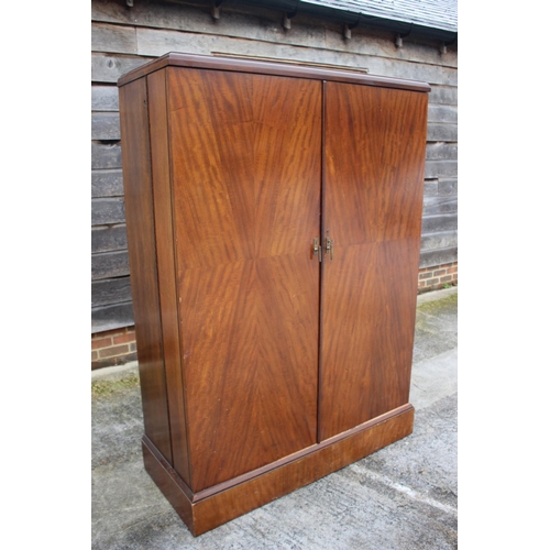 557 - An early 20th century mahogany Compactum wardrobe, Model YCH with fully fitted interior enclosed two... 