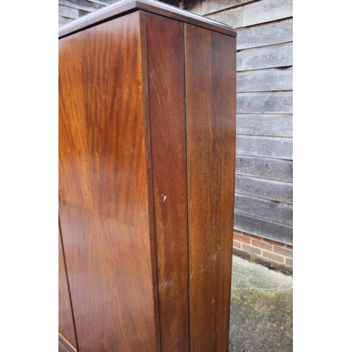 557 - An early 20th century mahogany Compactum wardrobe, Model YCH with fully fitted interior enclosed two... 