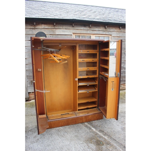 557 - An early 20th century mahogany Compactum wardrobe, Model YCH with fully fitted interior enclosed two... 