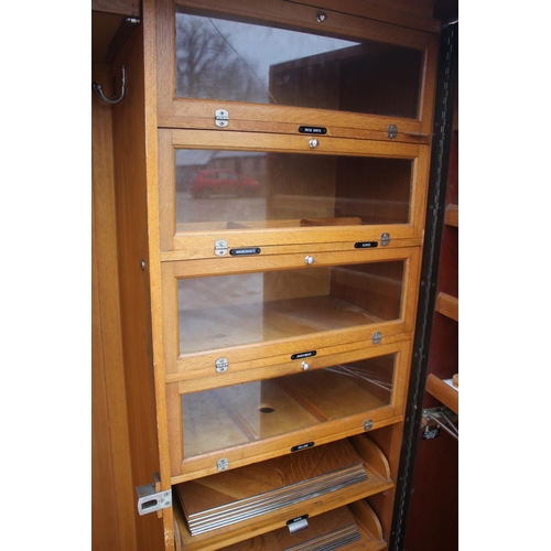 557 - An early 20th century mahogany Compactum wardrobe, Model YCH with fully fitted interior enclosed two... 