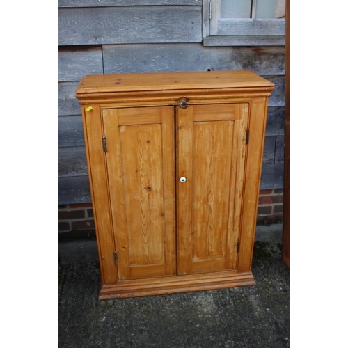 559 - A waxed pine cupboard enclosed two doors, on block base, 32