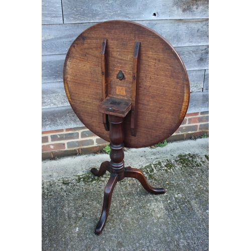 562 - A mahogany circular tilt top occasional table, on turned column and tripod splayed support, 28 1/2