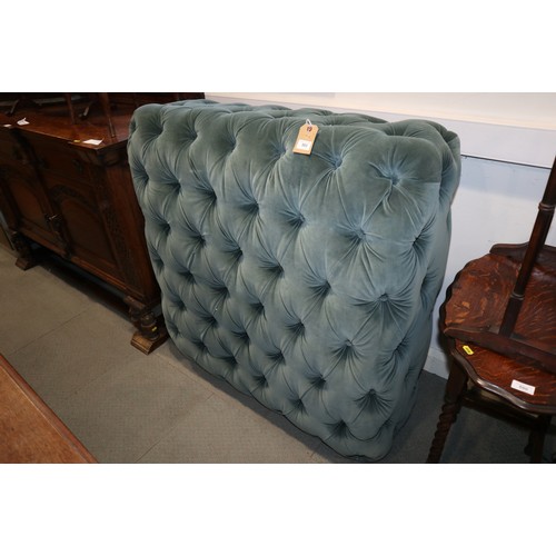 553 - An OKA ottoman, button upholstered in a blue green velour, on turned supports, 42