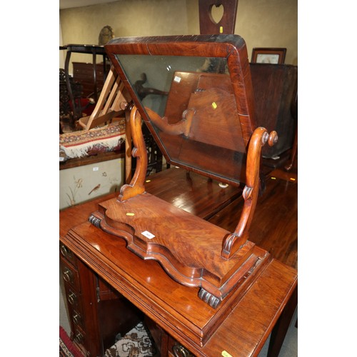 568 - A mahogany swing frame toilet mirror, on serpentine base, 21 1/4