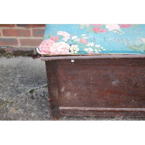 570 - A long oak window seat with lift up lid, covered in a floral fabric worn, 91