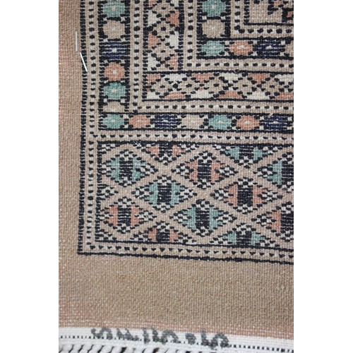 582 - A Bokhara rug of traditional design with thirty-six central elephant guls and multi-bordered in shad... 