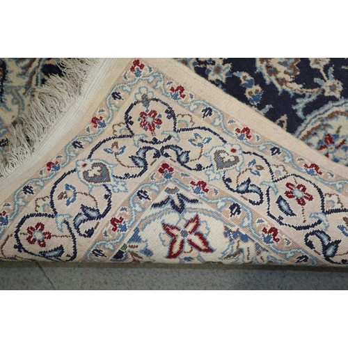 585 - A Persian prayer rug with all-over scroll design on a blue and cream ground, 44